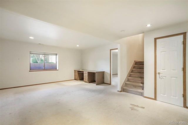 174 Luxury Ln, Colorado Springs, CO 80921 - below grade area featuring stairway, light carpet, and recessed lighting