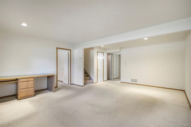 174 Luxury Ln, Colorado Springs, CO 80921 - unfurnished room featuring stairs, light colored carpet, and recessed lighting