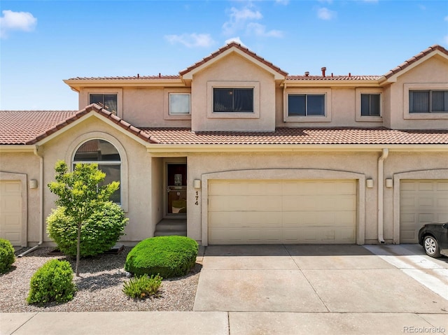 174 Luxury Ln, Colorado Springs, CO 80921 - townhome / multi-family property with a tiled roof, concrete driveway, and stucco siding