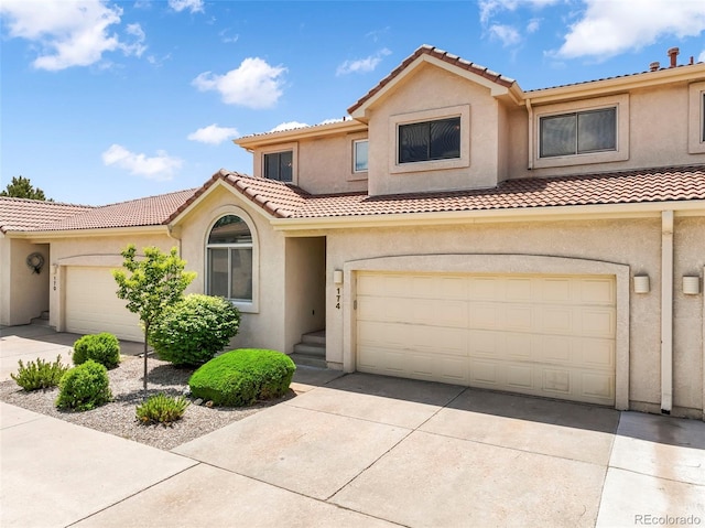 174 Luxury Ln, Colorado Springs, CO 80921 - view of front of home featuring a tiled roof, driveway, and stucco siding