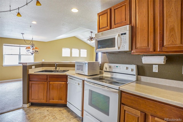 9311 Amison Cir Unit 204, Parker, CO 80134 - kitchen featuring white appliances, brown cabinets, plenty of natural light, a textured ceiling, and recessed lighting