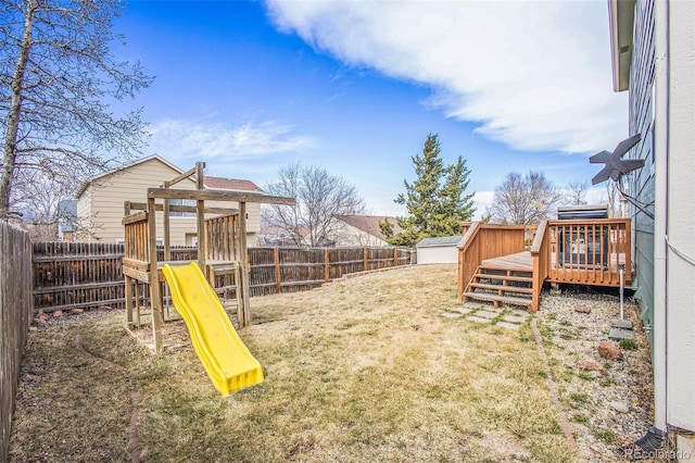 2870 Harrisburg Way, Colorado Springs, CO 80922 - view of yard featuring a fenced backyard, a wooden deck, and a playground
