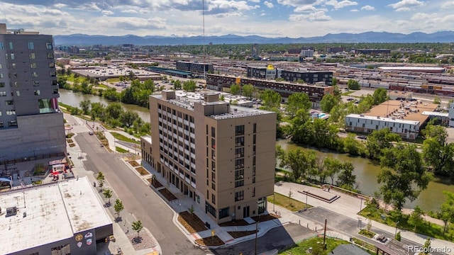 drone / aerial view featuring a view of city and a water and mountain view