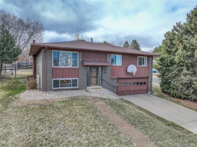 split foyer home featuring brick siding, concrete driveway, an attached garage, and fence