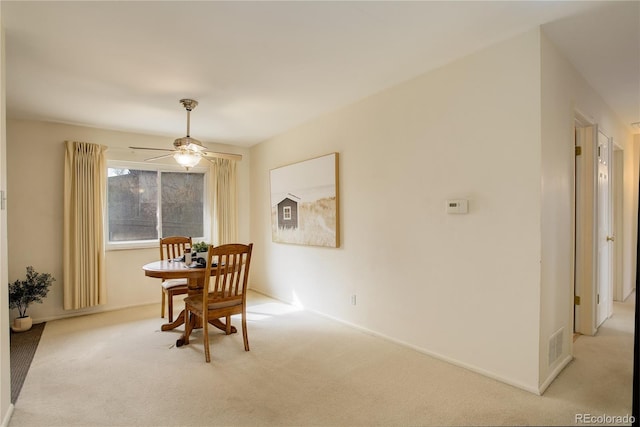 dining room with baseboards, carpet floors, and ceiling fan