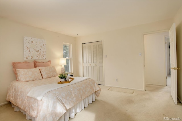 carpeted bedroom featuring a closet and baseboards