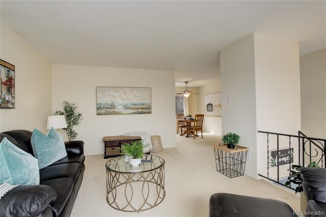 living area with carpet floors and a ceiling fan