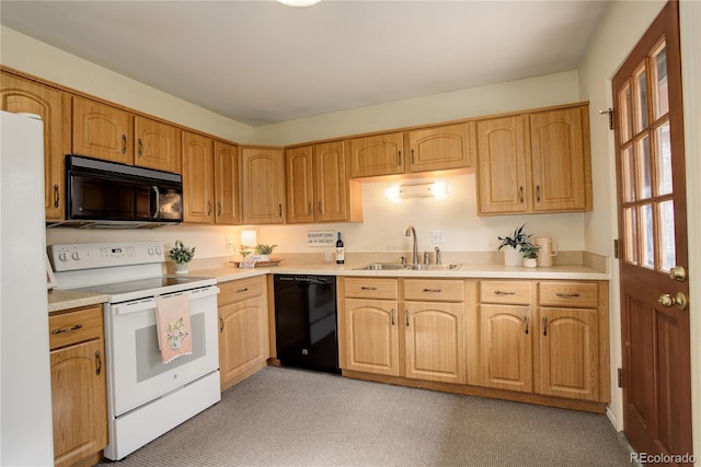 kitchen featuring black appliances, light countertops, and a sink