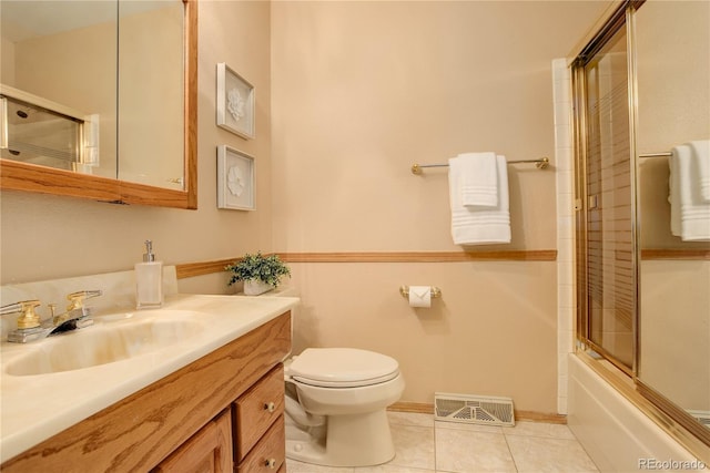 bathroom featuring vanity, visible vents, tile patterned flooring, toilet, and combined bath / shower with glass door