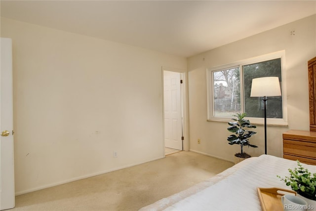 bedroom featuring baseboards and carpet