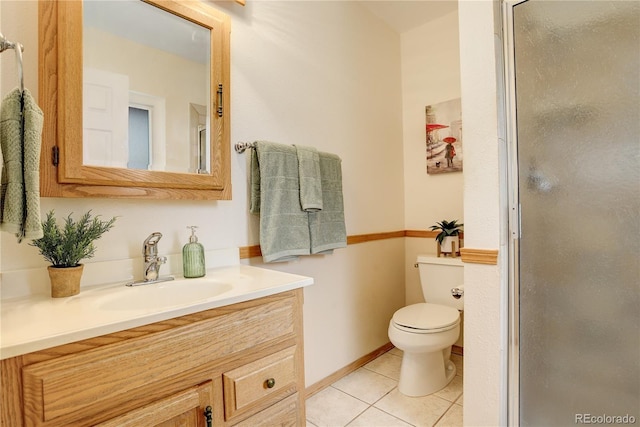 bathroom with vanity, tile patterned floors, toilet, and a shower stall