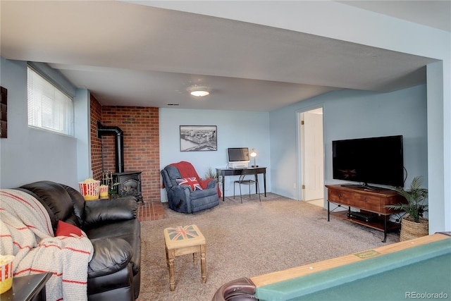 carpeted living room with visible vents and a wood stove