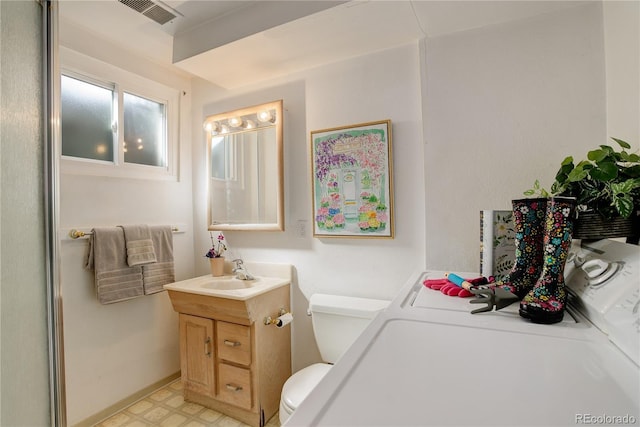 bathroom featuring vanity, visible vents, washer and dryer, tile patterned floors, and toilet