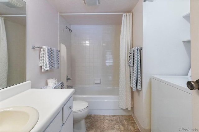 full bathroom with shower / bath combination with curtain, toilet, washer / dryer, and vanity