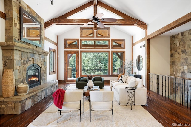 living room featuring a fireplace, beamed ceiling, high vaulted ceiling, wood-type flooring, and ceiling fan