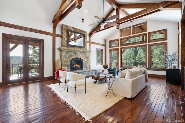 living room with a stone fireplace, beam ceiling, dark wood-type flooring, high vaulted ceiling, and ceiling fan