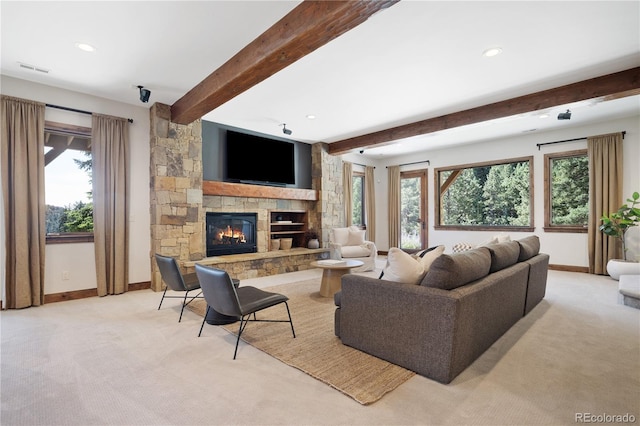 living room featuring light carpet, beamed ceiling, and a stone fireplace