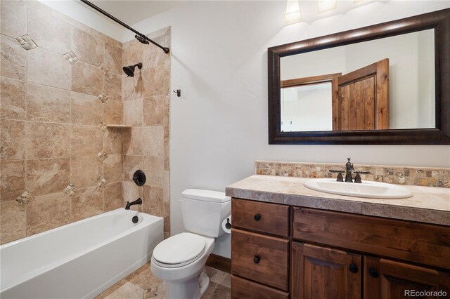 full bathroom featuring vanity, toilet, and tiled shower / bath