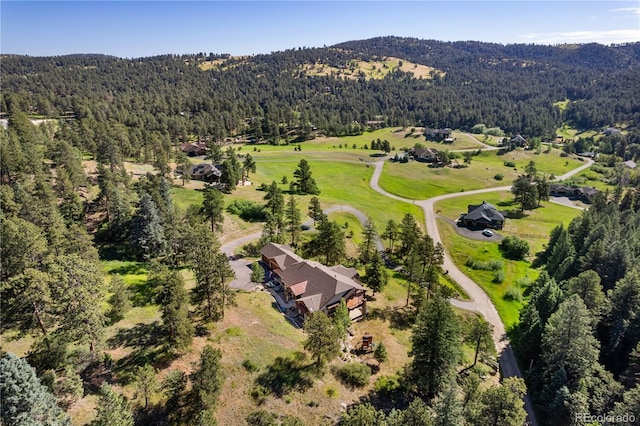 aerial view featuring a wooded view