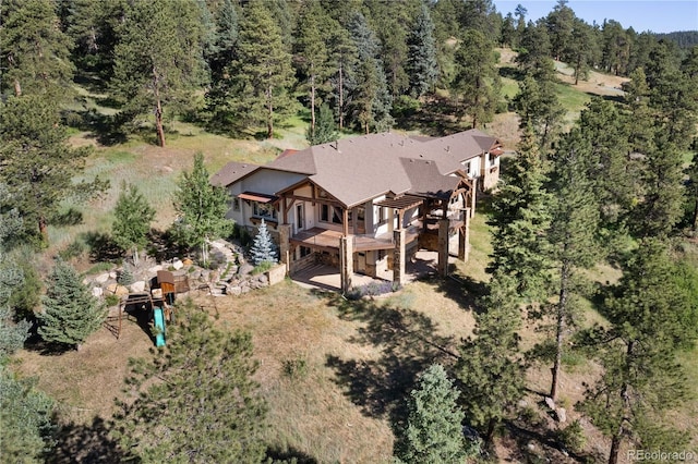 birds eye view of property with a wooded view