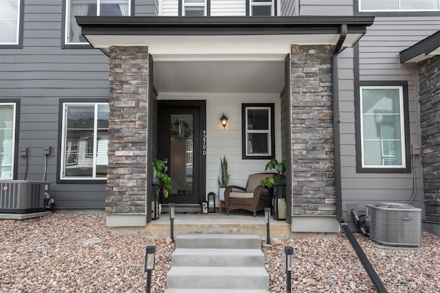 9250 Garnett Way Unit D, Arvada, CO 80007 - property entrance featuring a porch and stone siding