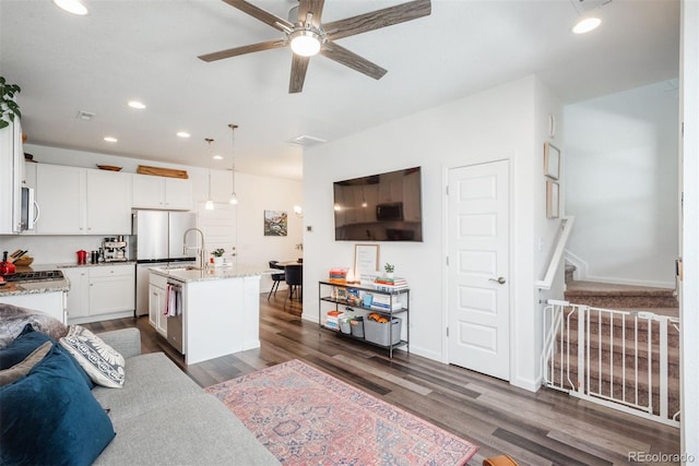 9250 Garnett Way Unit D, Arvada, CO 80007 - living area with a ceiling fan, dark wood-style floors, stairway, and recessed lighting