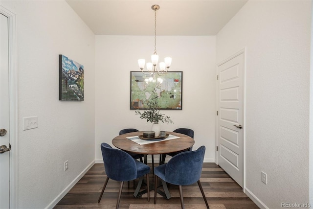 9250 Garnett Way Unit D, Arvada, CO 80007 - dining area with a chandelier and dark wood-style flooring