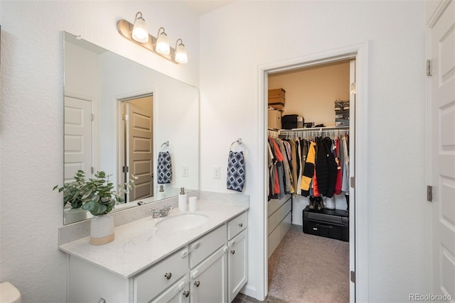 9250 Garnett Way Unit D, Arvada, CO 80007 - bathroom featuring vanity and a spacious closet