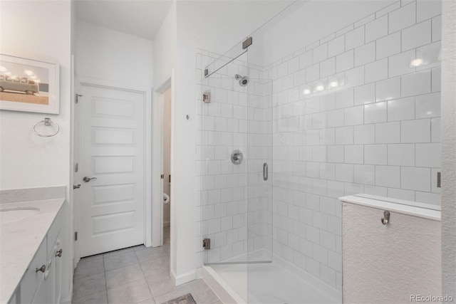 9250 Garnett Way Unit D, Arvada, CO 80007 - bathroom with a shower stall, tile patterned flooring, and vanity