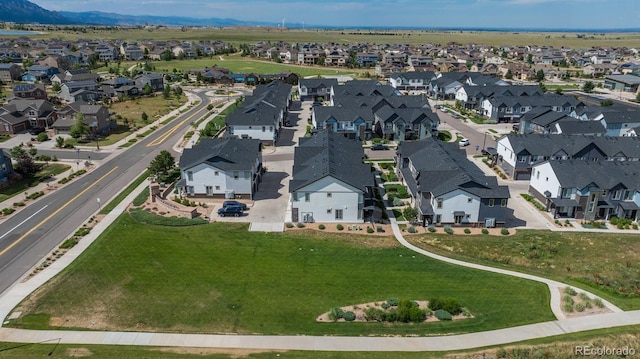 9250 Garnett Way Unit D, Arvada, CO 80007 - aerial view of property's location with nearby suburban area and a mountain backdrop