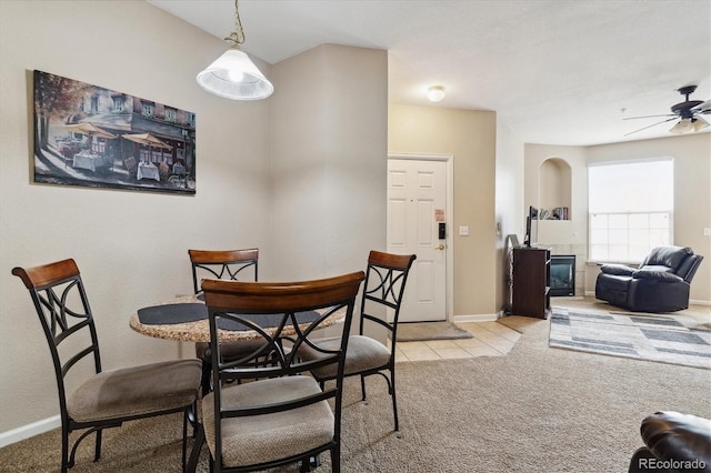 carpeted dining area featuring ceiling fan