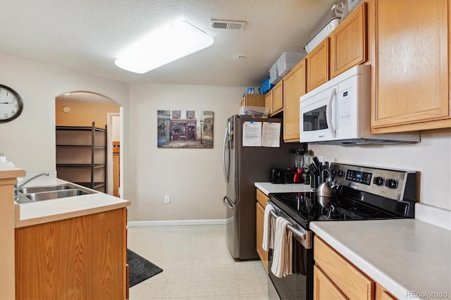 kitchen with sink, a textured ceiling, and stainless steel electric range oven