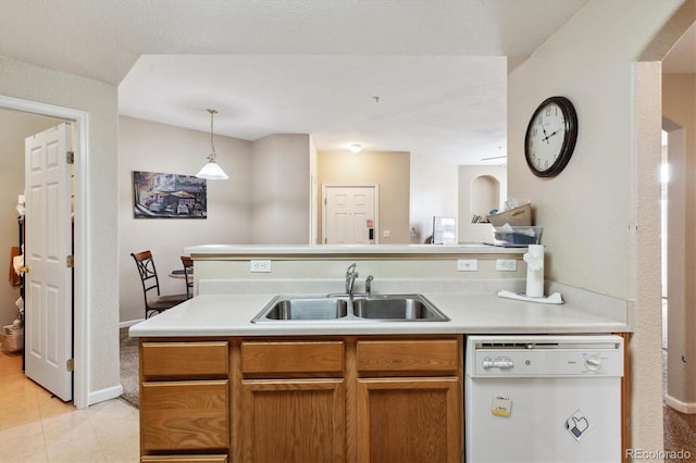 kitchen with sink, pendant lighting, and dishwasher