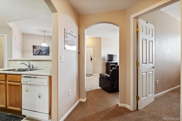 hall featuring sink and light colored carpet