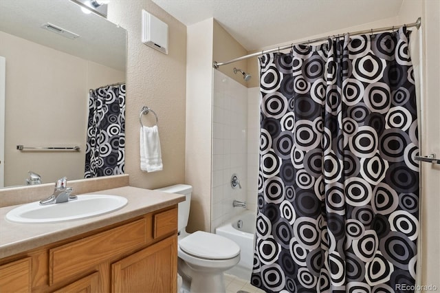 bathroom featuring a textured ceiling, toilet, and vanity