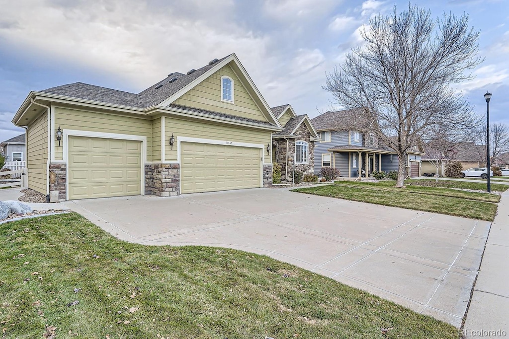 view of front of home with a garage and a front lawn