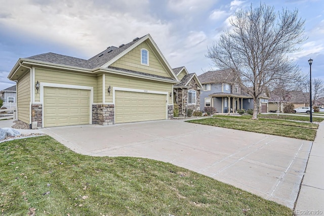 view of front of home with a garage and a front lawn