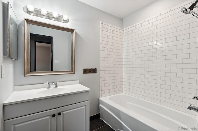 bathroom featuring vanity, tiled shower / bath, and tile patterned flooring