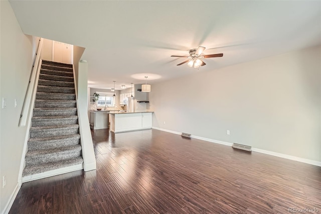 6492 Simms St Unit A, Arvada, CO 80004 - unfurnished living room featuring ceiling fan, baseboards, stairs, and dark wood-type flooring