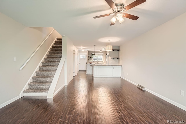 6492 Simms St Unit A, Arvada, CO 80004 - unfurnished living room featuring stairway, dark wood-type flooring, ceiling fan, and baseboards