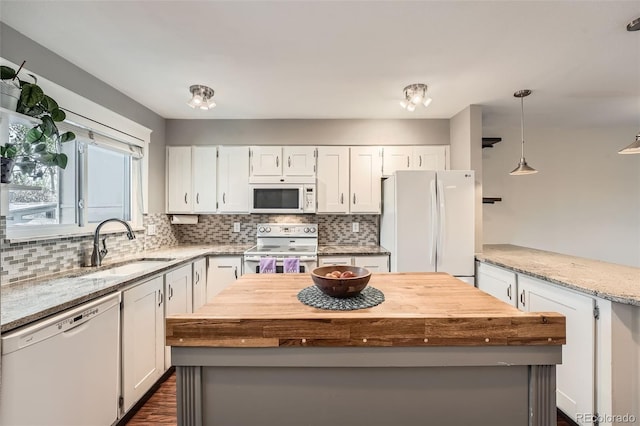 6492 Simms St Unit A, Arvada, CO 80004 - kitchen with white appliances, a sink, backsplash, and white cabinets