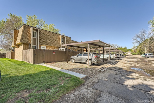 6492 Simms St Unit A, Arvada, CO 80004 - view of property exterior featuring mansard roof, covered parking, and roof with shingles