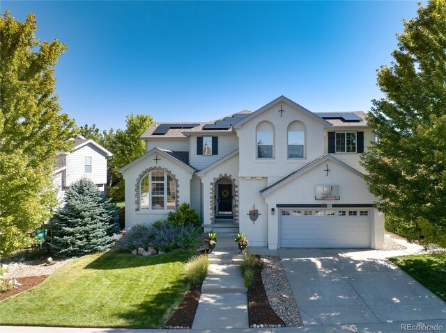 2880 Breezy Ln, Castle Rock, CO 80109 - view of front facade featuring solar panels, a garage, driveway, and a front yard
