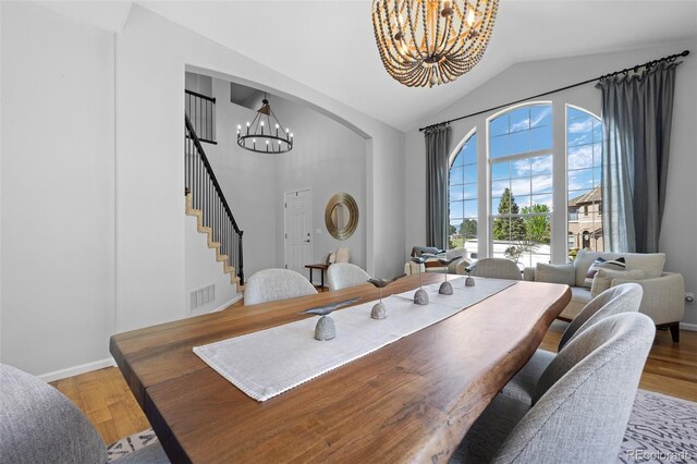 2880 Breezy Ln, Castle Rock, CO 80109 - dining room with a chandelier, high vaulted ceiling, wood finished floors, stairs, and baseboards