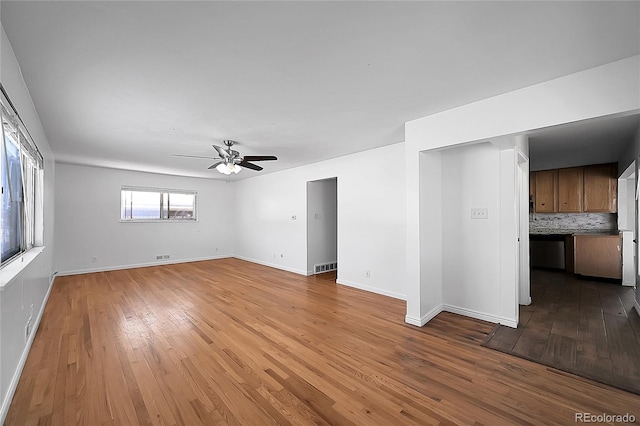 spare room with light wood-type flooring and ceiling fan