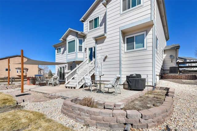 rear view of house with a patio and central AC