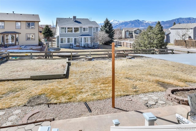 view of yard featuring fence and a mountain view