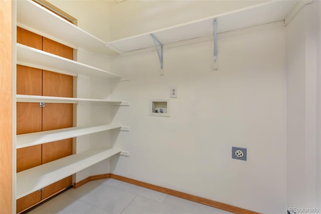 laundry room featuring laundry area, hookup for a washing machine, electric dryer hookup, and baseboards