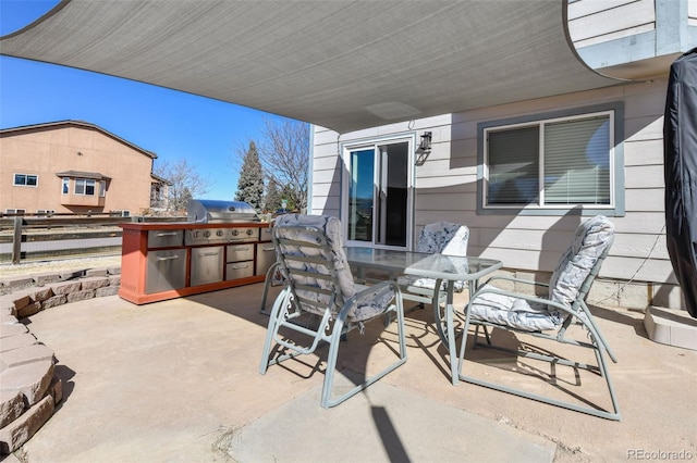 view of patio with grilling area, an outdoor kitchen, and outdoor dining area