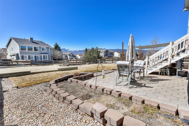 view of yard featuring a patio area, a fenced backyard, and a mountain view